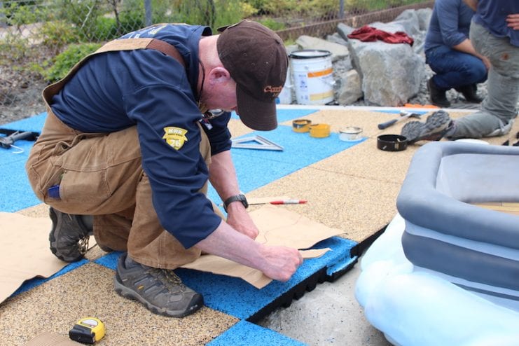 Rich MacIntyre lays the composite surface tiles.