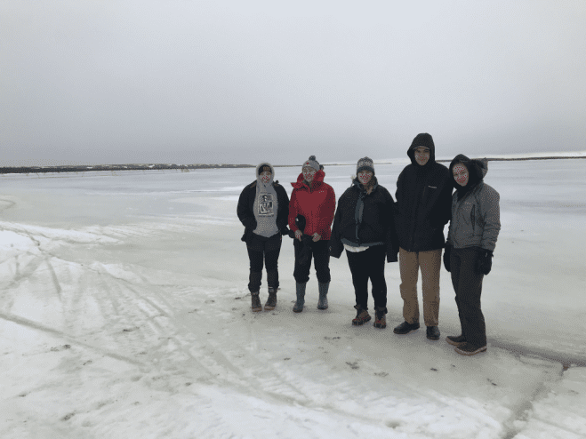 Sitka High students, standing on the frozen Kuskokwim river in Napakiak. "Later in the week, we went ice fishing and caught lots of pike," Keri Gray said. (Photo courtesy of  Keri Gray)