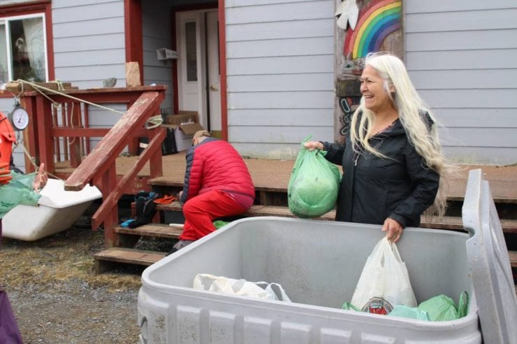 Tribal council chair KathyHope Erickson stops by the Kaa Toowú Náagu Hídi to collect some bags of herring eggs. (KCAW photo / Enrique Pérez de la Rosa)