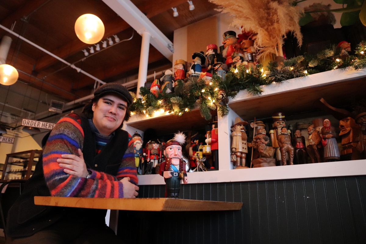 Jack Petersen poses with a portion of his nutcracker collection displayed at Wildflour Cafe and Bakery (KCAW/Cotter)