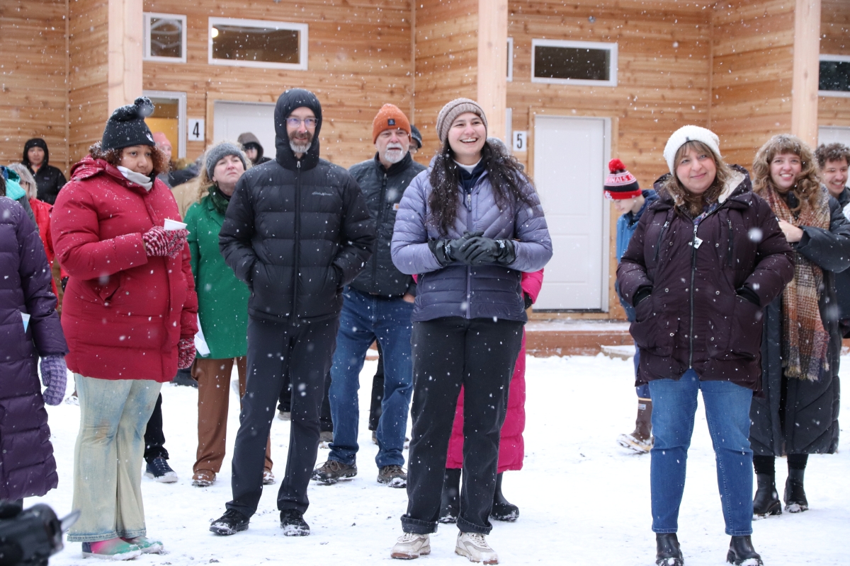 Denise Shaffer stands amongst Sitka Homeless Coalition staff and supporters watching the speakers commemorate the event