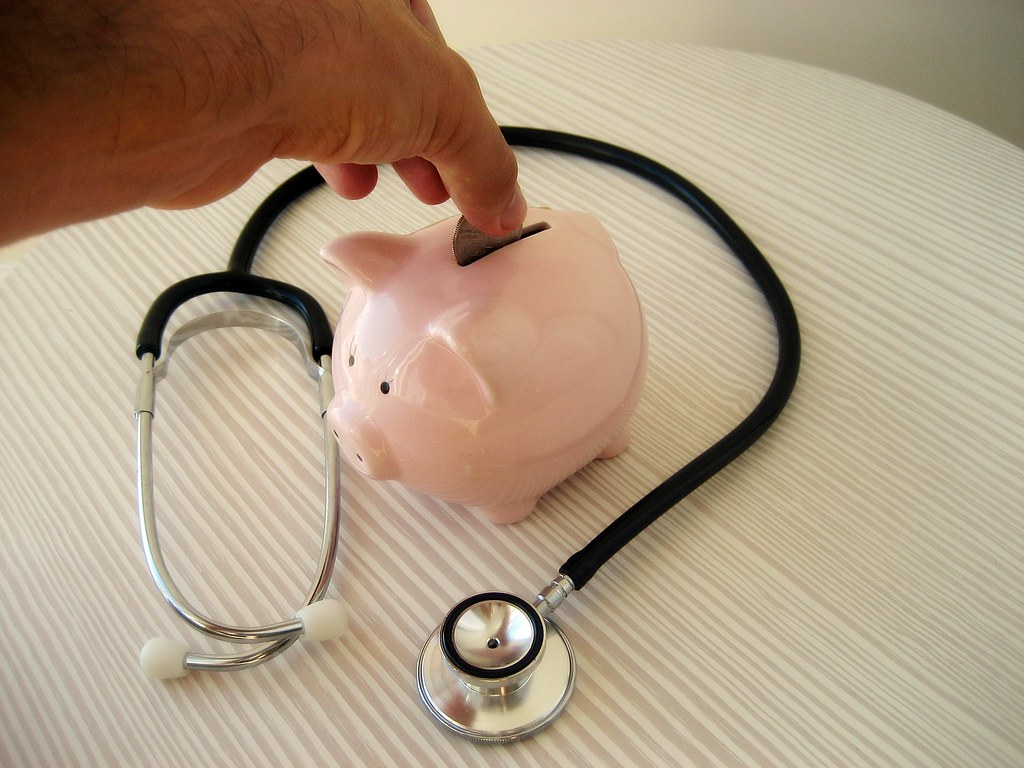 The current image has no alternative text. The file name is: Stethoscope-and-piggy-bank.jpg